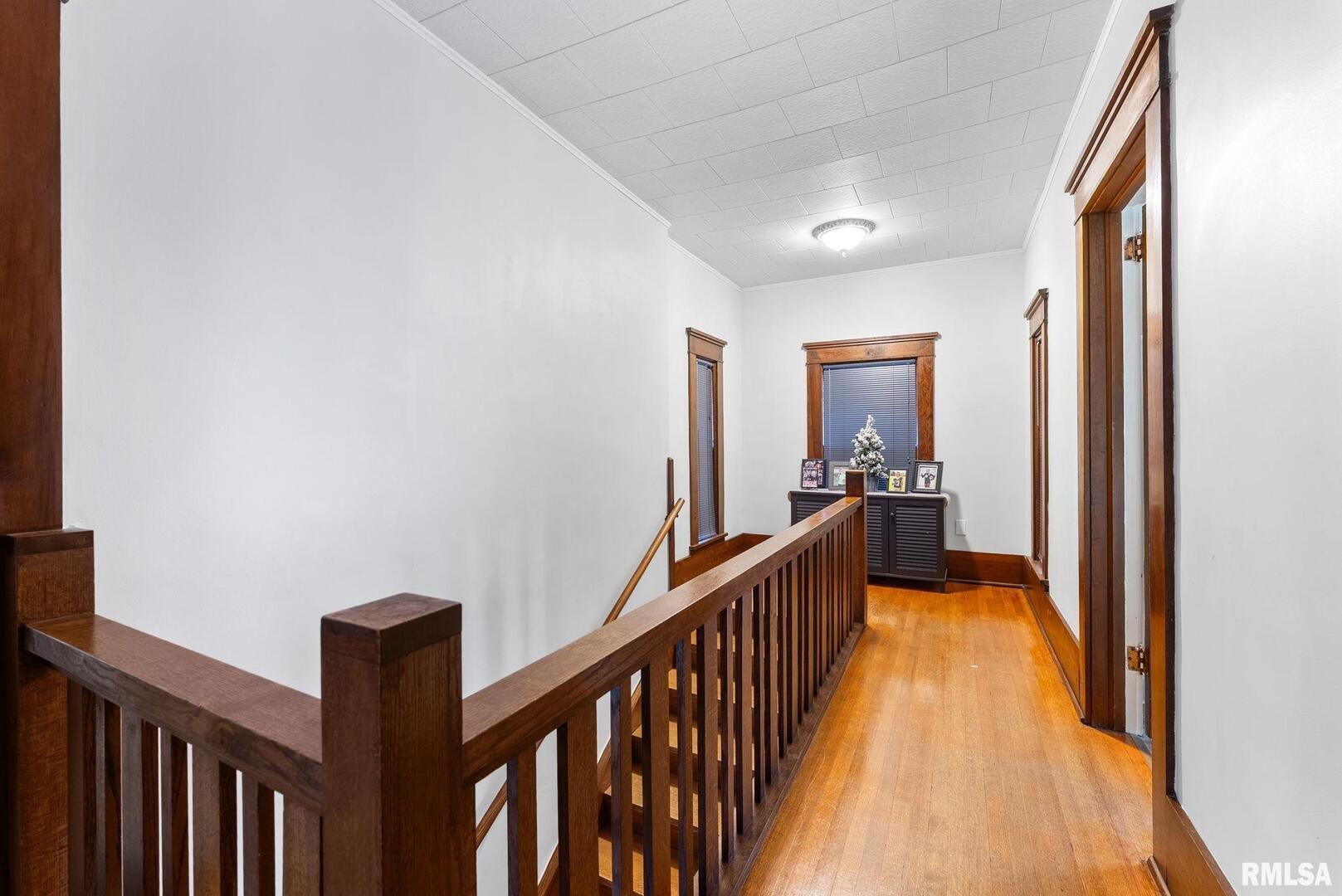 308 Northeast 3rd Avenue Aledo, IL 61231 - Photo 23 of 28 a view of a hallway with wooden floor and stairs