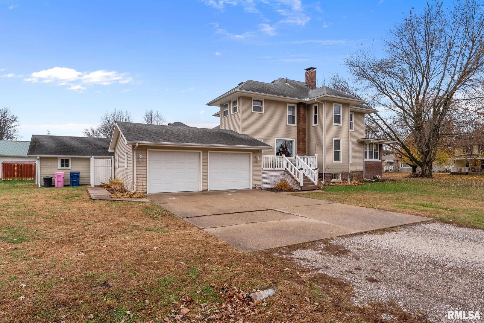 308 Northeast 3rd Avenue Aledo, IL 61231 - Photo 27 of 28 a front view of a house with a yard and garage