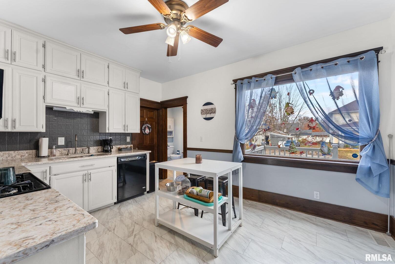 308 Northeast 3rd Avenue Aledo, IL 61231 - Photo 7 of 28 a kitchen with a stove a refrigerator and a stove top oven