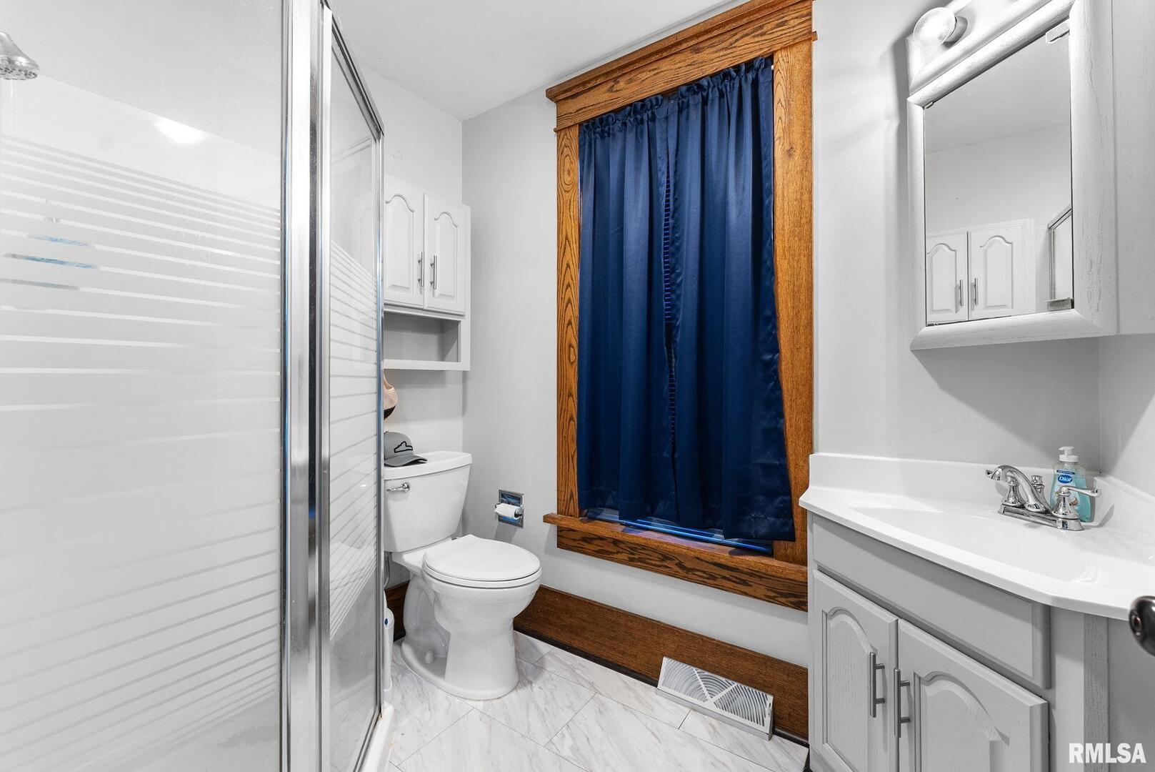 308 Northeast 3rd Avenue Aledo, IL 61231 - Photo 10 of 28 a bathroom with a sink a toilet and shower