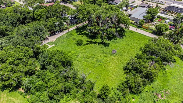 an aerial view of residential house with outdoor space and trees all around