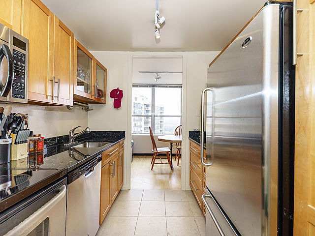 655 West Irving Park Road, Unit 2716 Chicago, IL 60613 - Photo 12 of 25 a kitchen with stainless steel appliances granite countertop a sink and a refrigerator