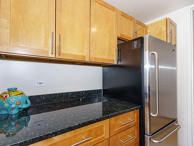 655 West Irving Park Road, Unit 2716 Chicago, IL 60613 - Photo 13 of 25 a kitchen with granite countertop a sink and a refrigerator