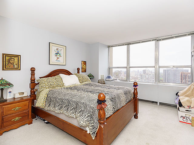 655 West Irving Park Road, Unit 2716 Chicago, IL 60613 - Photo 15 of 25 a bed sitting in a bedroom next to a window