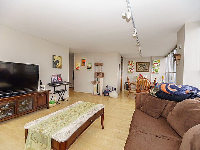 655 West Irving Park Road, Unit 2716 Chicago, IL 60613 - Photo 5 of 25 a living room with furniture and a flat screen tv