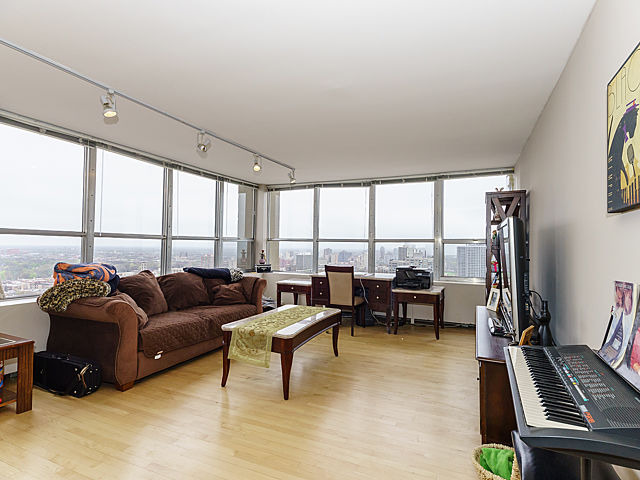 655 West Irving Park Road, Unit 2716 Chicago, IL 60613 - Photo 6 of 25 a living room with furniture and a floor to ceiling window