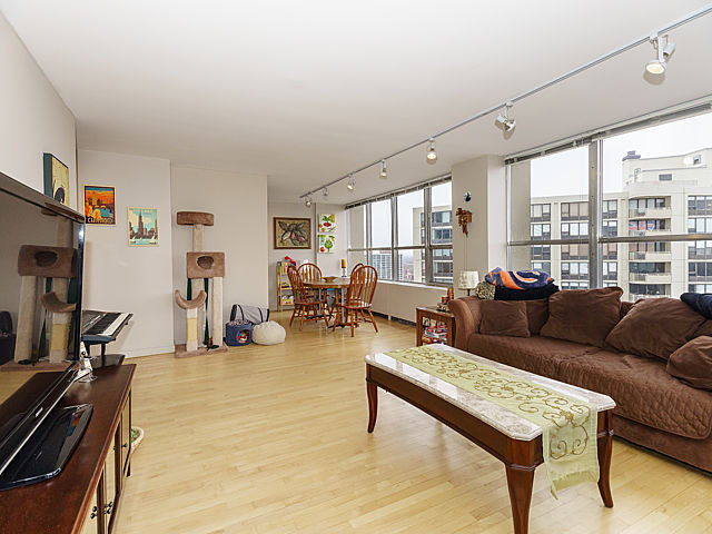 655 West Irving Park Road, Unit 2716 Chicago, IL 60613 - Photo 7 of 25 a living room with furniture and a flat screen tv