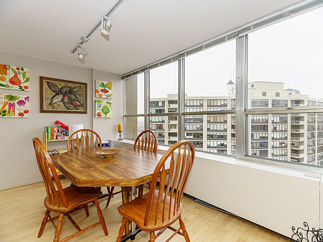 655 West Irving Park Road, Unit 2716 Chicago, IL 60613 - Photo 8 of 25 a view of a dining room with furniture a chandelier and wooden floor