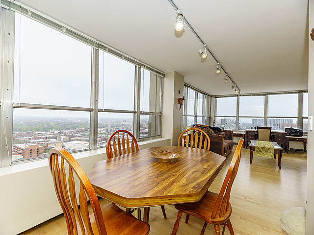 655 West Irving Park Road, Unit 2716 Chicago, IL 60613 - Photo 9 of 25 a dining room with furniture window and wooden floor