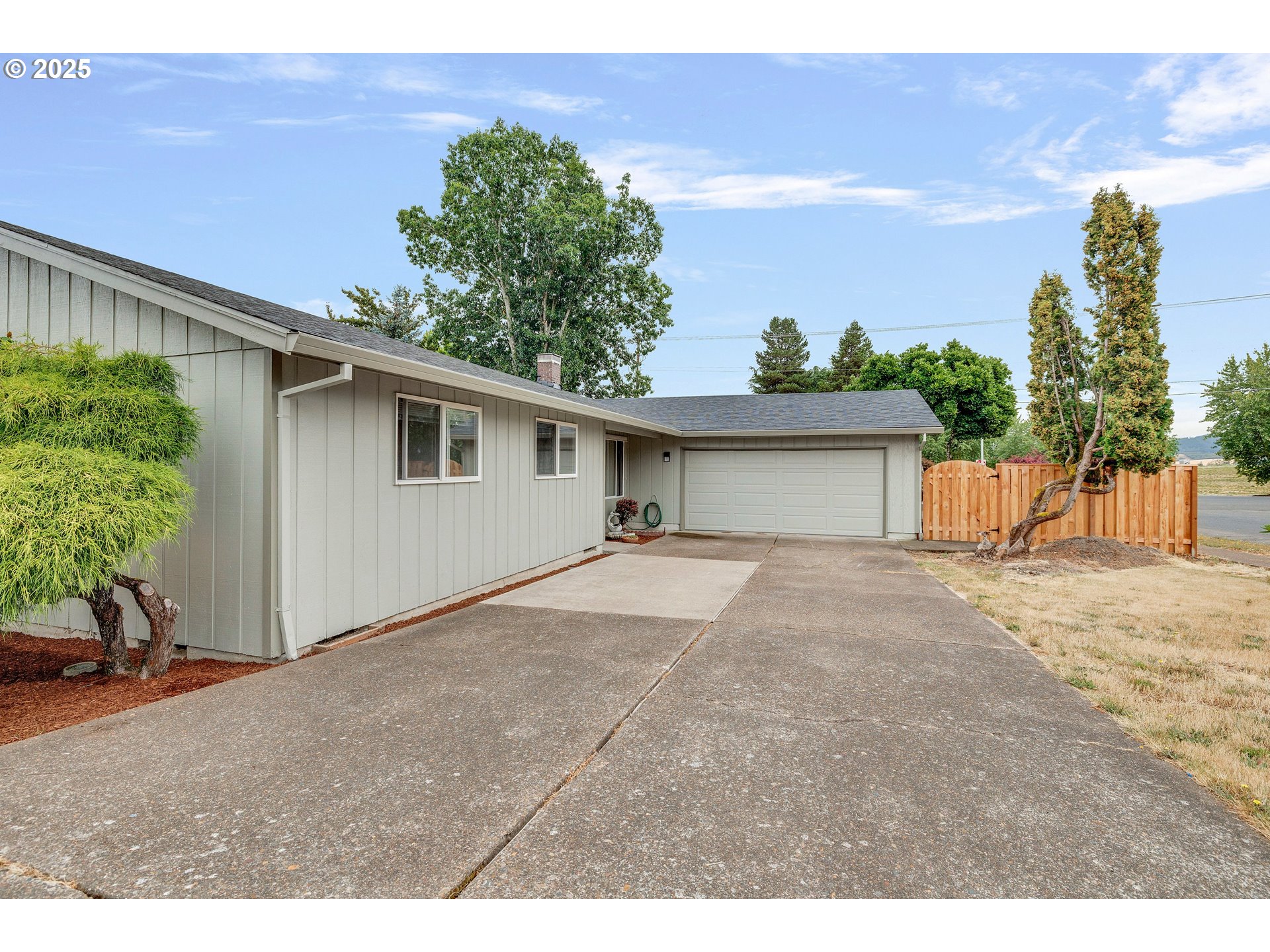 210 Forest Place Forest Grove, OR 97116 - Photo 13 of 35 a view of a house with a backyard and a garage