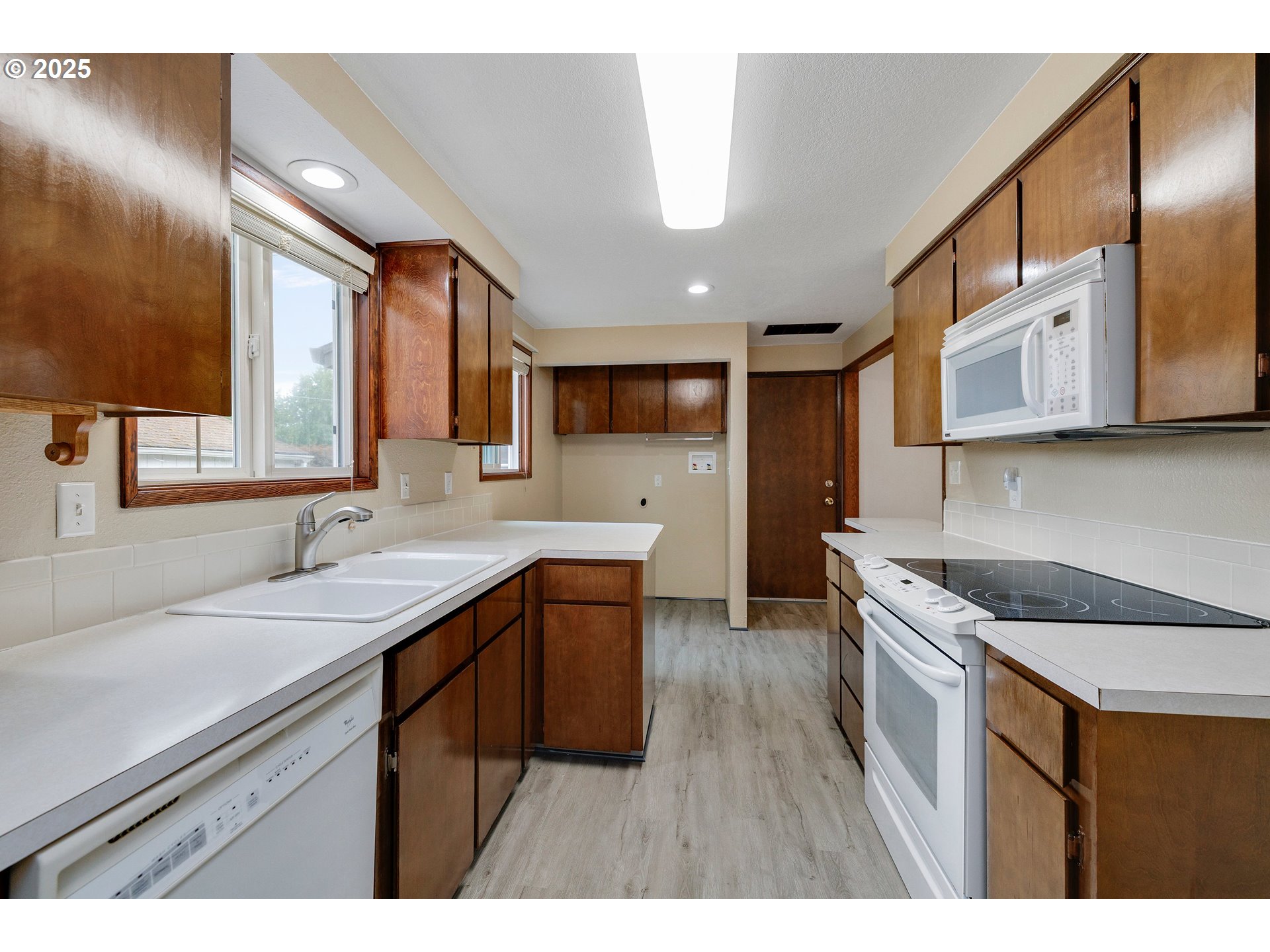 210 Forest Place Forest Grove, OR 97116 - Photo 21 of 35 a kitchen that has a sink a stove and cabinets