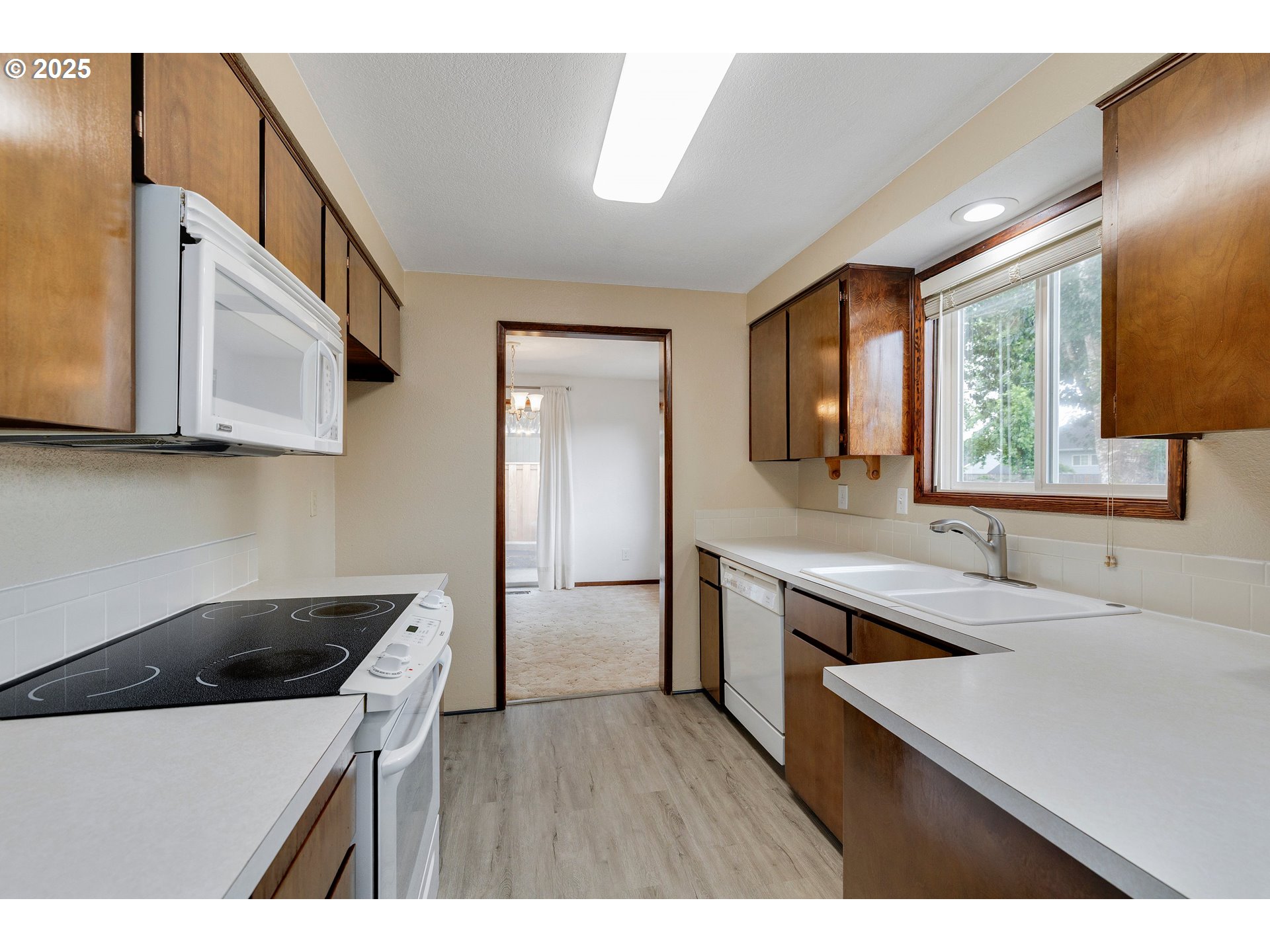 210 Forest Place Forest Grove, OR 97116 - Photo 24 of 35 a kitchen with a sink a stove and cabinets