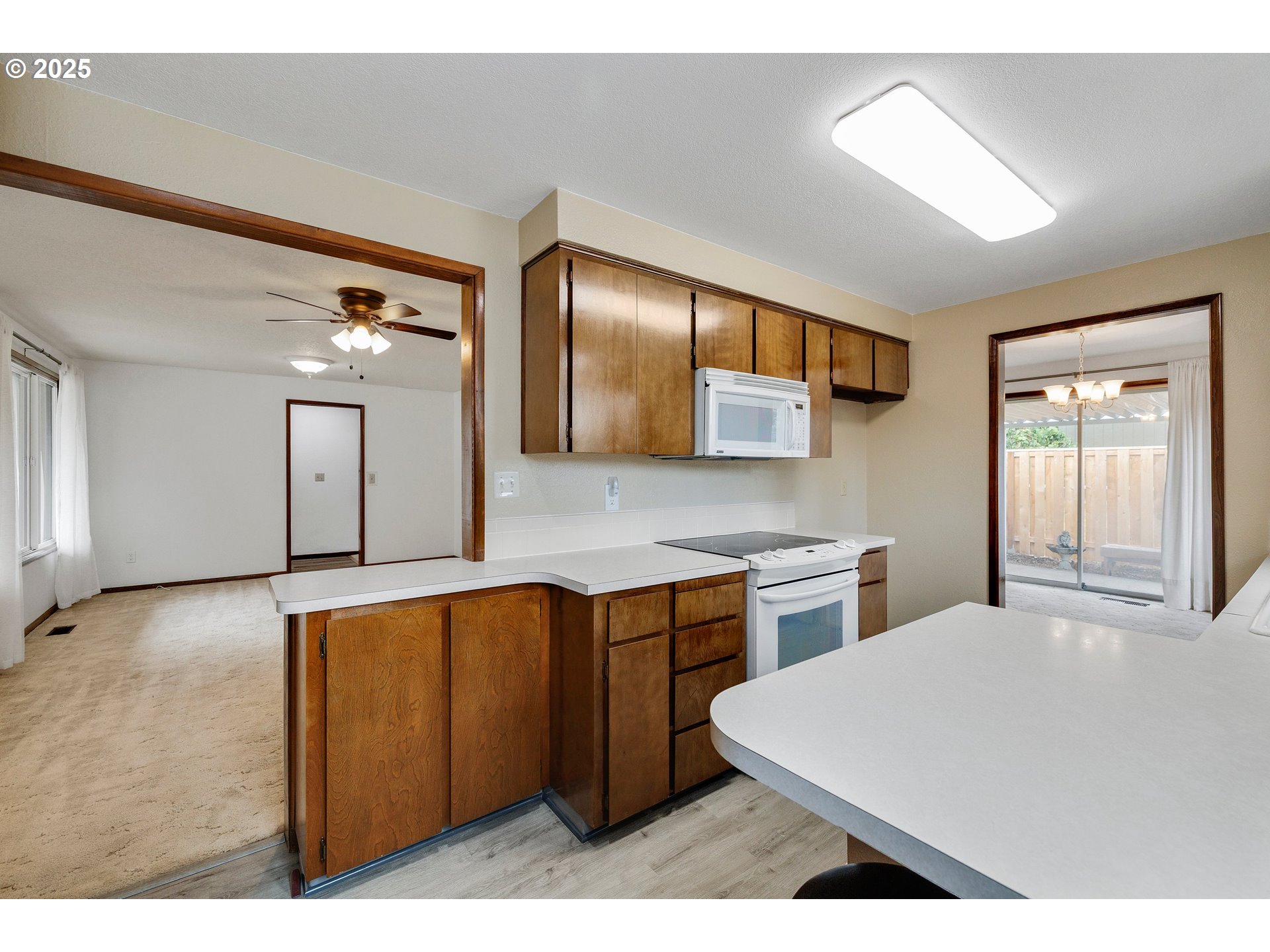 210 Forest Place Forest Grove, OR 97116 - Photo 25 of 35 a kitchen with a stove a sink and a refrigerator