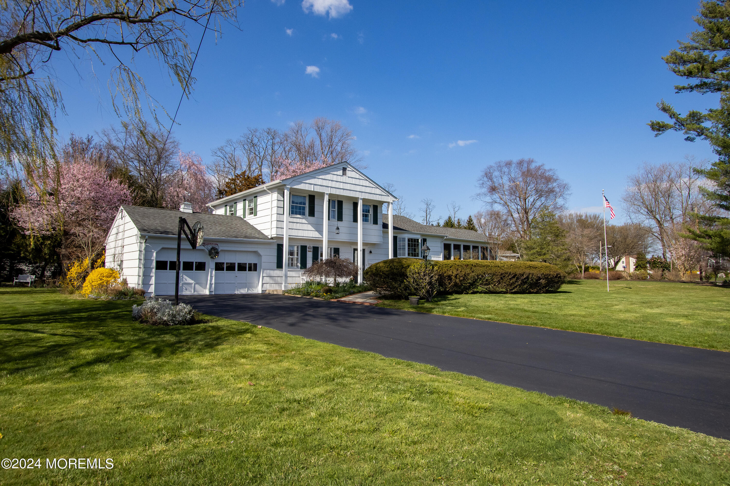 21 Rivers Edge Drive Little Silver, NJ 07739 - Photo 42 of 56 a front view of a house with a yard table and chairs