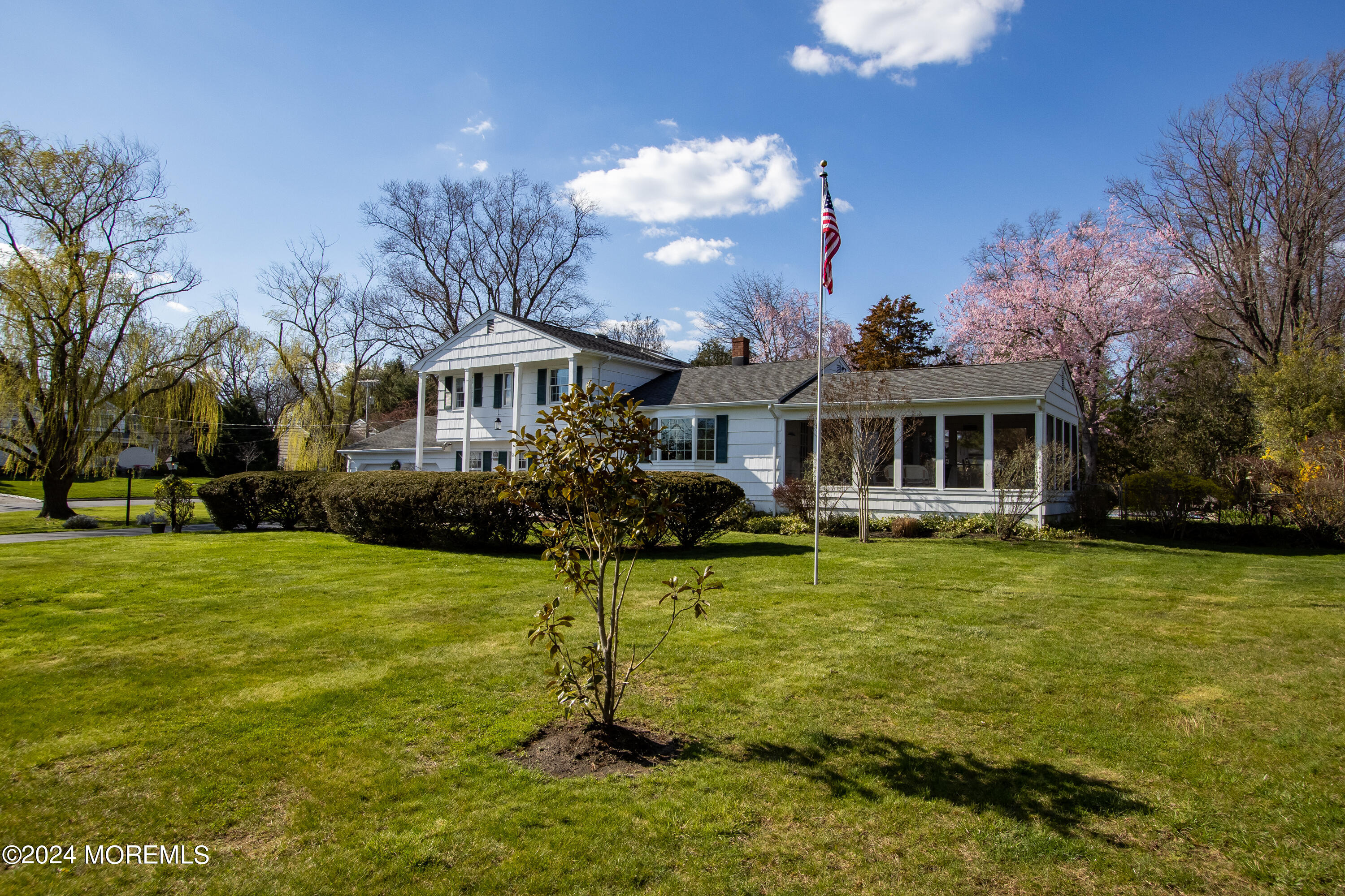 21 Rivers Edge Drive Little Silver, NJ 07739 - Photo 45 of 56 a front view of a house with a yard table and chairs