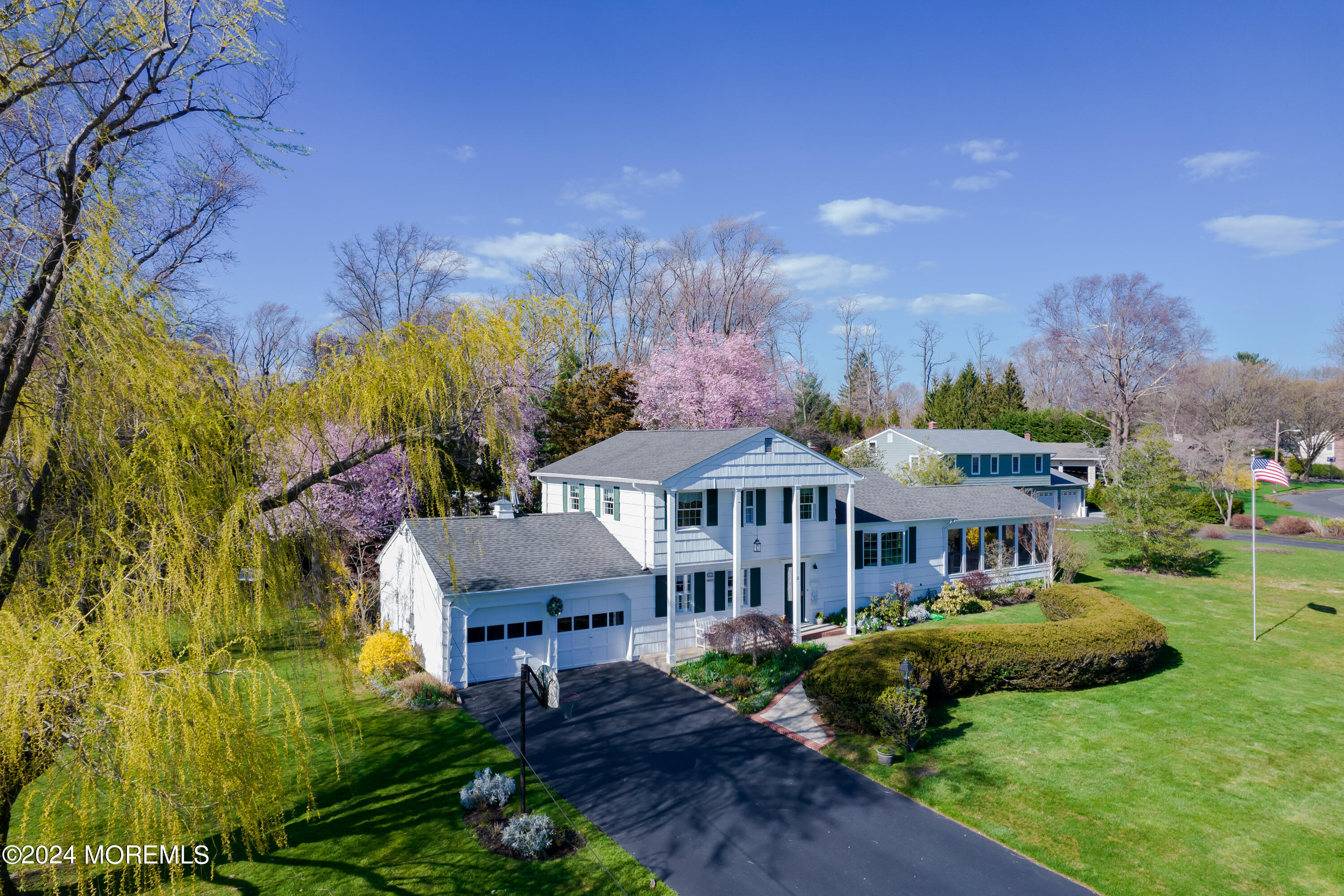 21 Rivers Edge Drive Little Silver, NJ 07739 - Photo 49 of 56 a front view of a house with a yard and large trees