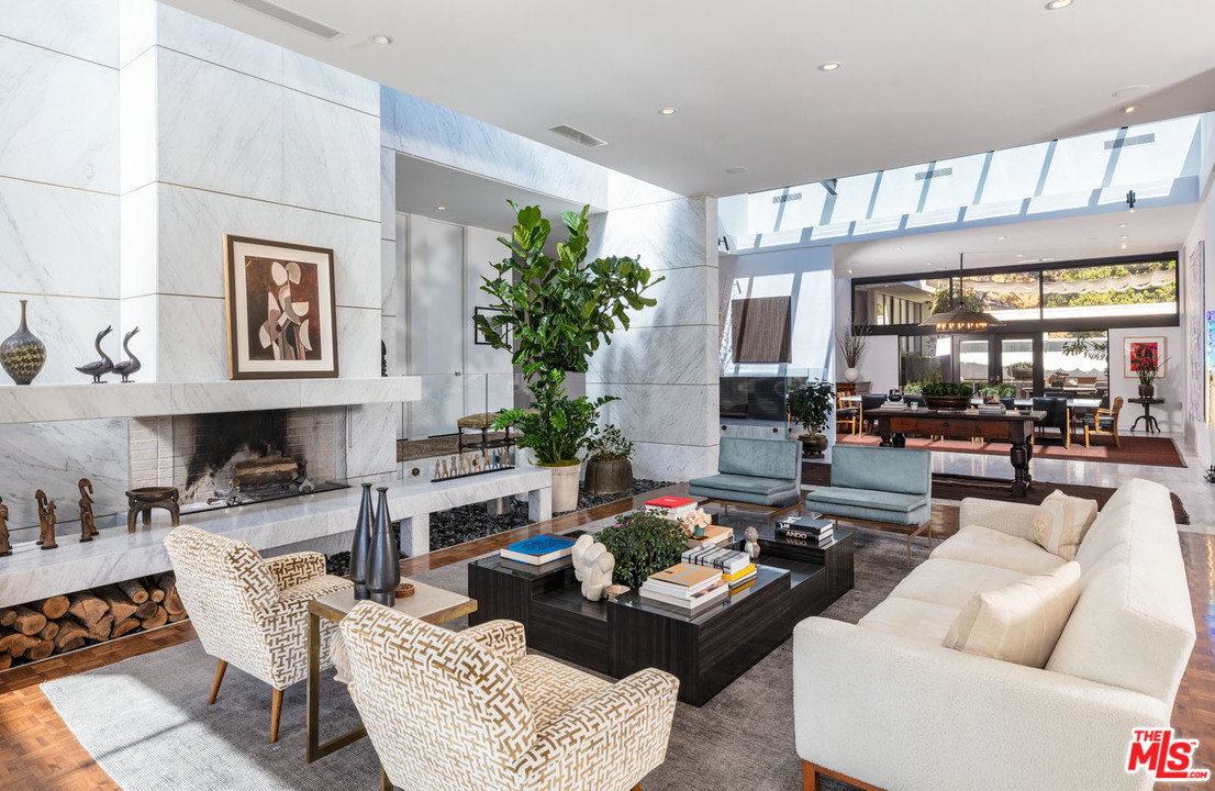 North Hillcrest Road Beverly Hills, CA 90210 - Photo 12 of 34 a living room with fireplace furniture and a large window