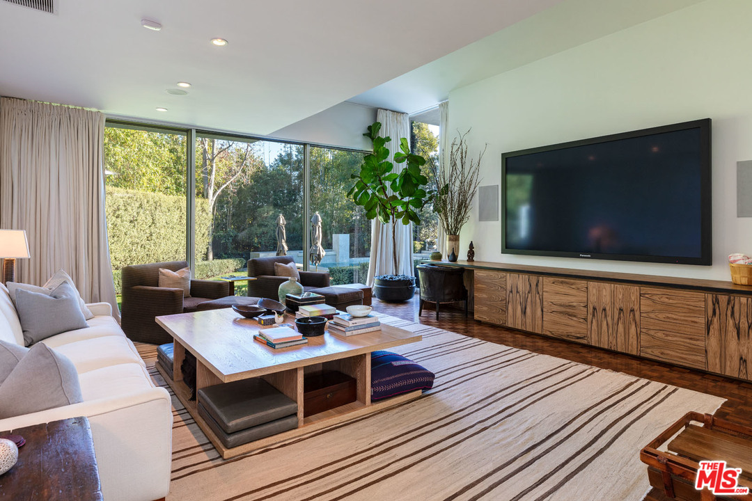 North Hillcrest Road Beverly Hills, CA 90210 - Photo 20 of 34 a living room with furniture and a flat screen tv