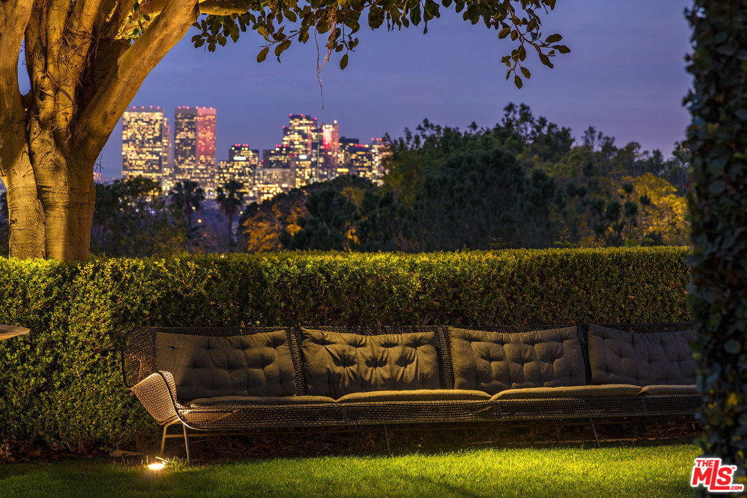 North Hillcrest Road Beverly Hills, CA 90210 - Photo 31 of 34 a view of a lake with couches chairs and a fire pit