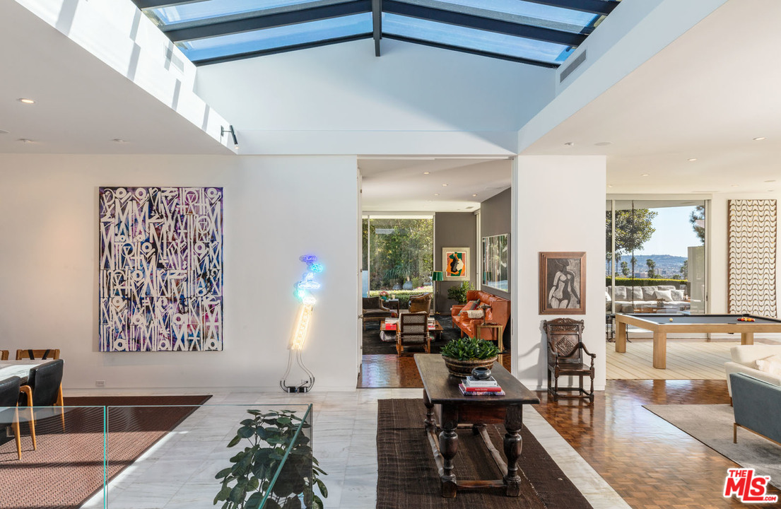 North Hillcrest Road Beverly Hills, CA 90210 - Photo 6 of 34 a living room with furniture and a flat screen tv