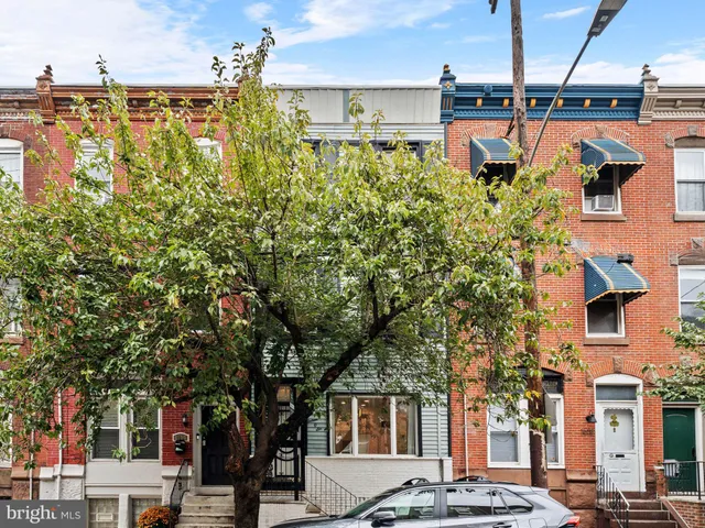 a front view of a building with a garden