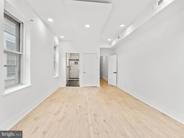 a big room with closet and windows