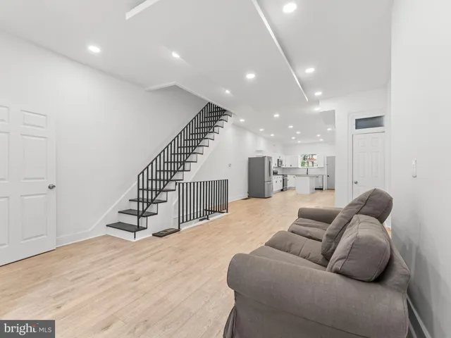 a living room with furniture or wooden floor and a ceiling fan