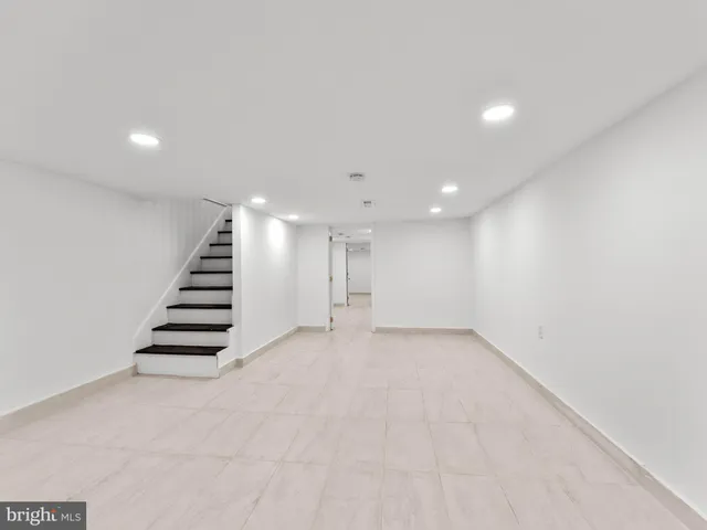 a view of an empty room with stairs