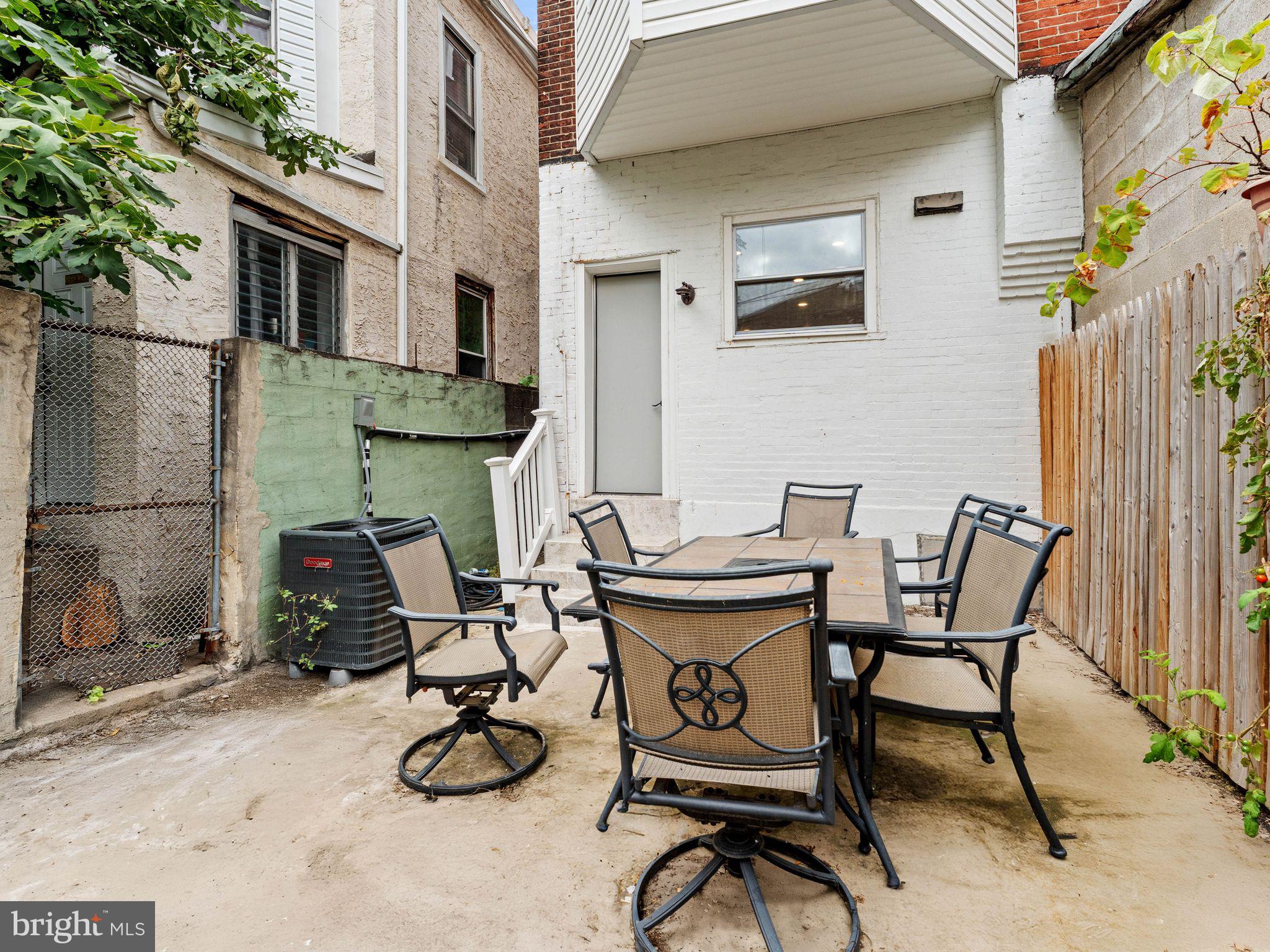 1606 Wharton Street Philadelphia, PA 19146 - Photo 30 of 31 a view of a patio with table and chairs with wooden floor and plants