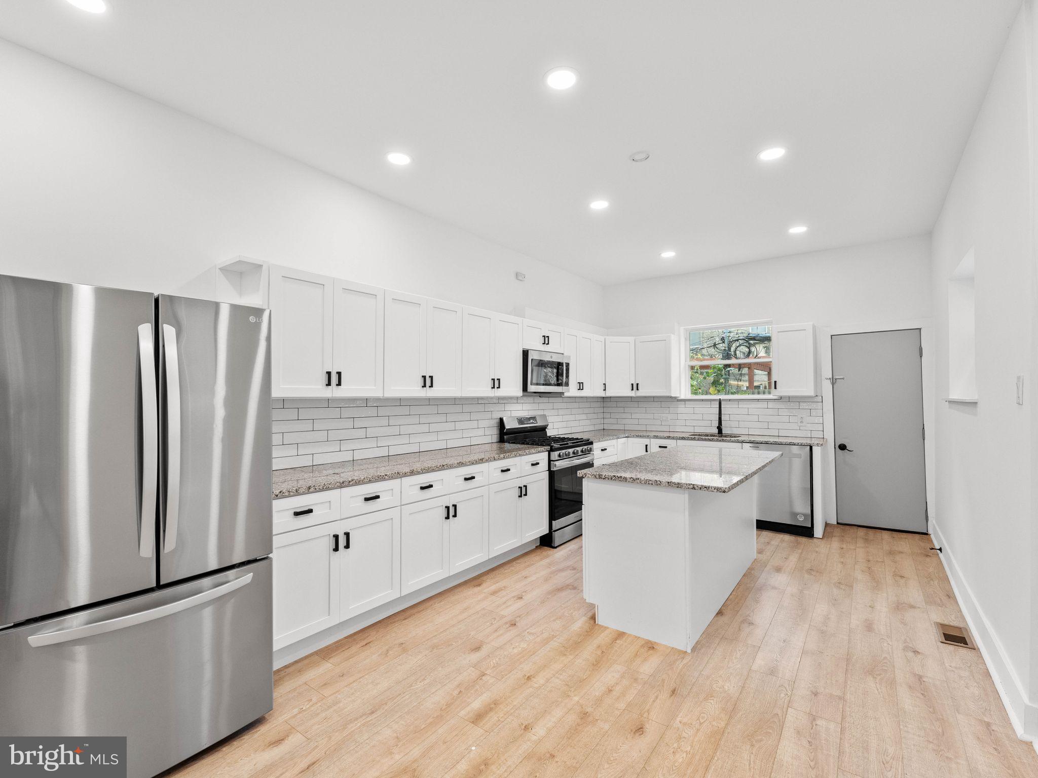 1606 Wharton Street Philadelphia, PA 19146 - Photo 5 of 31 a kitchen with stainless steel appliances a refrigerator sink and cabinets