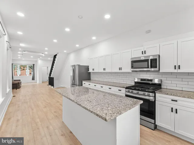 a kitchen with granite countertop a stove and a sink