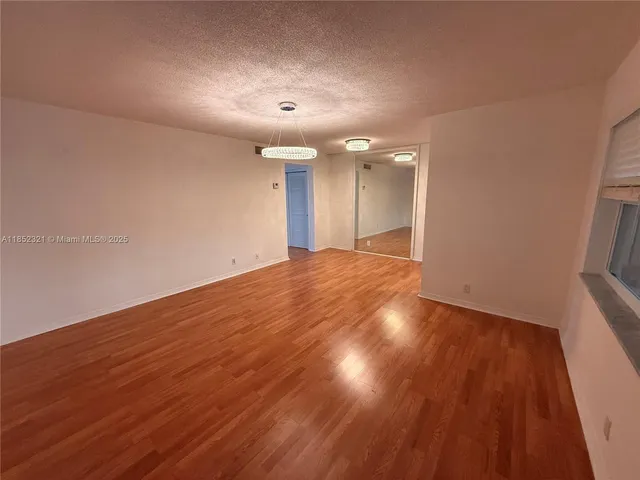 a view of a refrigerator in kitchen and wooden floor