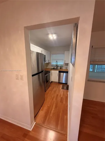 a kitchen with stainless steel appliances a refrigerator and a stove