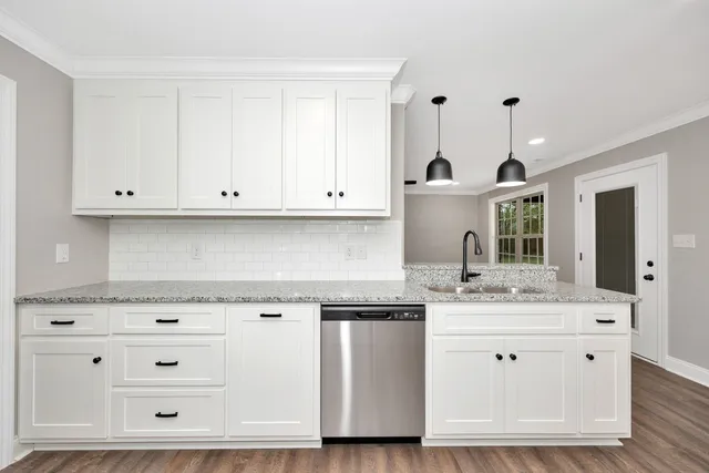 a view of white cabinets and sink