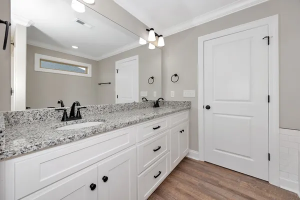a bathroom with double sink and a mirror