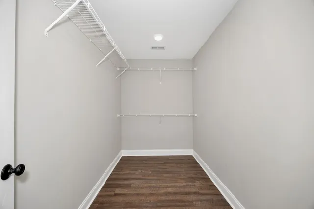 a view of a room with wooden floor and white walls