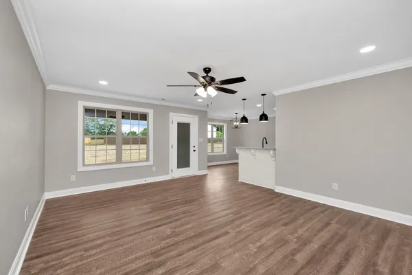 a view of an empty room with a kitchen