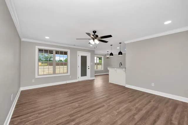 a view of an empty room with a kitchen