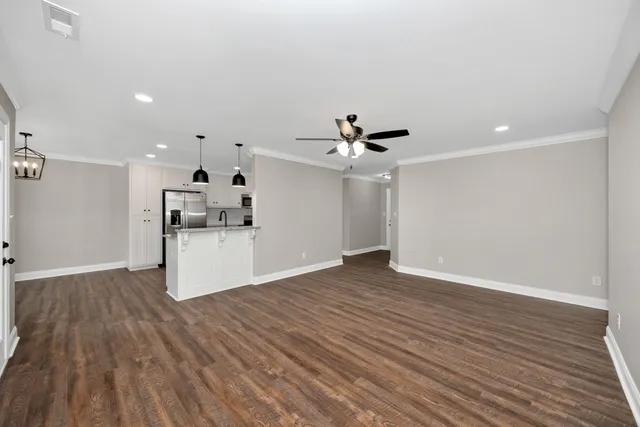 a view of kitchen cabinet with wooden floor and electronic appliances