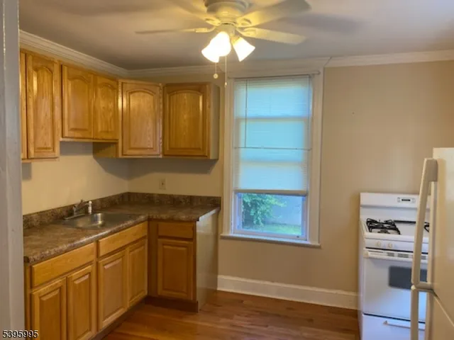 a kitchen with a stove a sink and a refrigerator