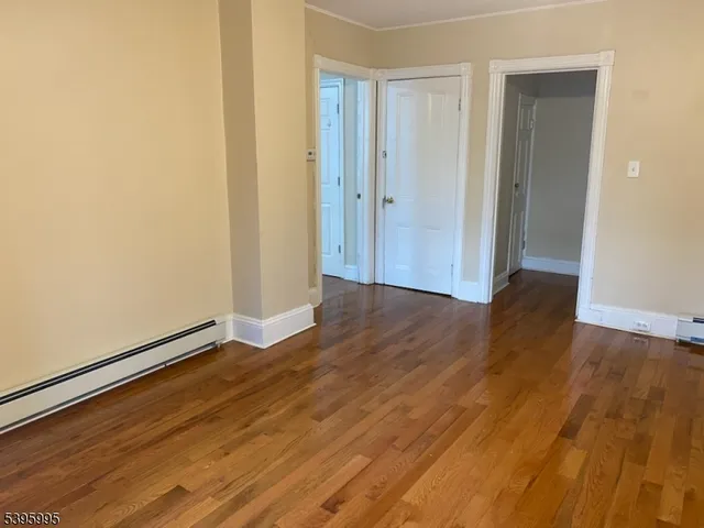 an empty room with wooden floor