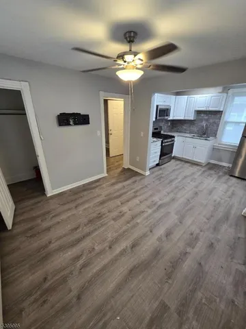 a view of a livingroom with a furniture wooden floor and window