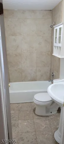 a bathroom with a toilet a sink and bathtub