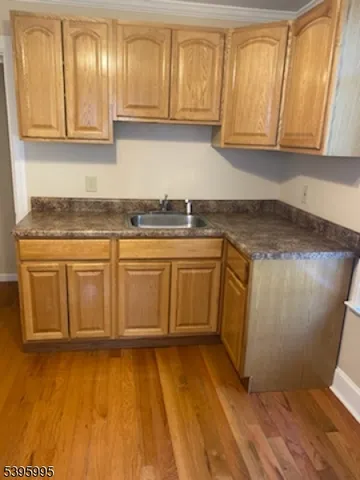 a kitchen with stainless steel appliances granite countertop a sink a stove and cabinets
