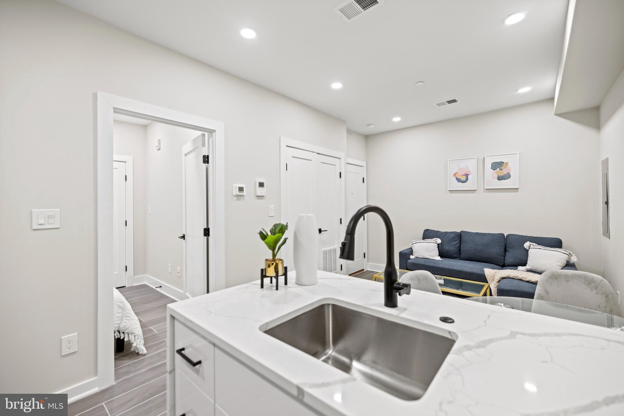 824 18th Street Northeast, Unit 3 Washington, DC 20002 - Photo 11 of 19 a kitchen with a sink cabinets and wooden floor