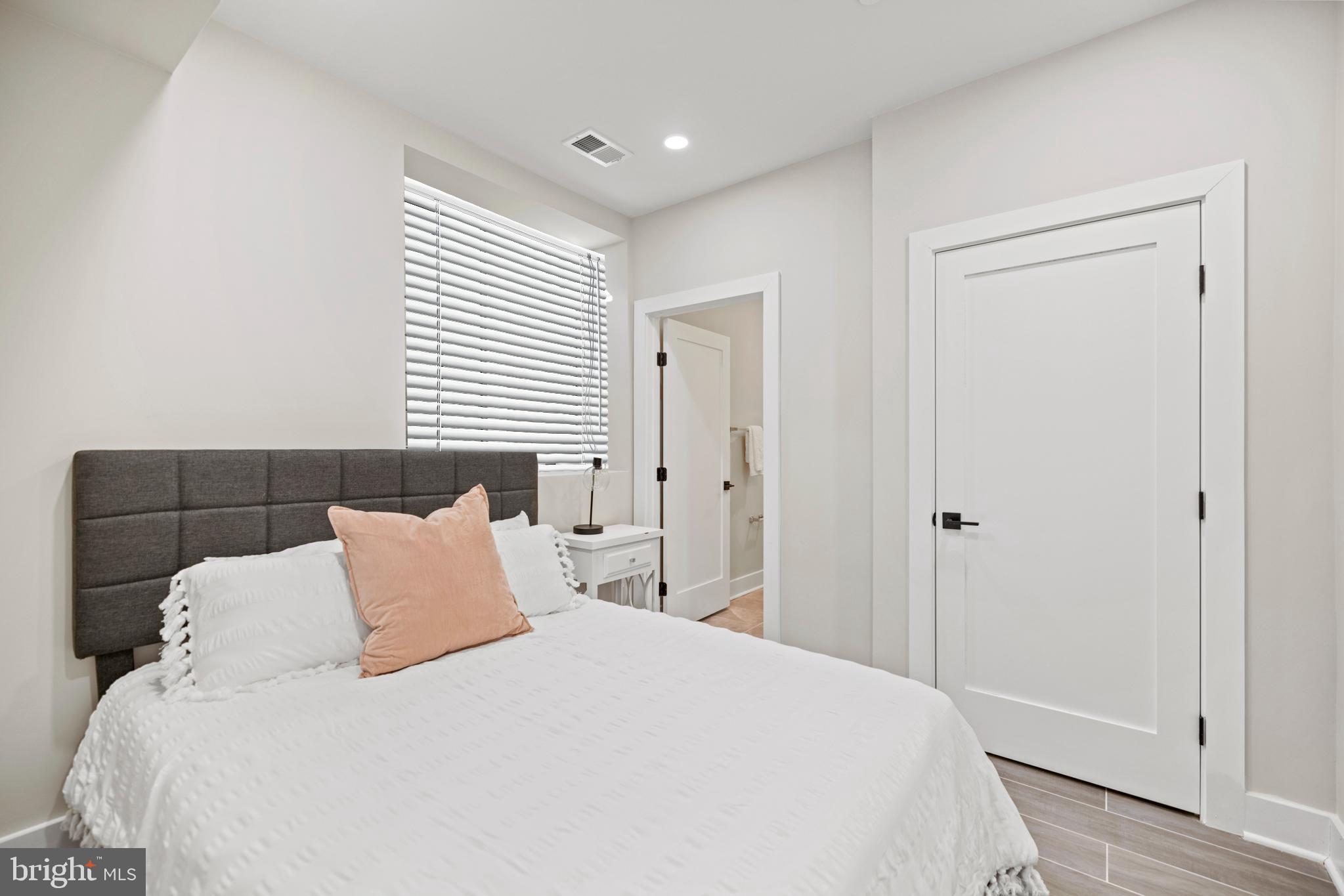 824 18th Street Northeast, Unit 3 Washington, DC 20002 - Photo 13 of 19 a bedroom with a bed and a mirror