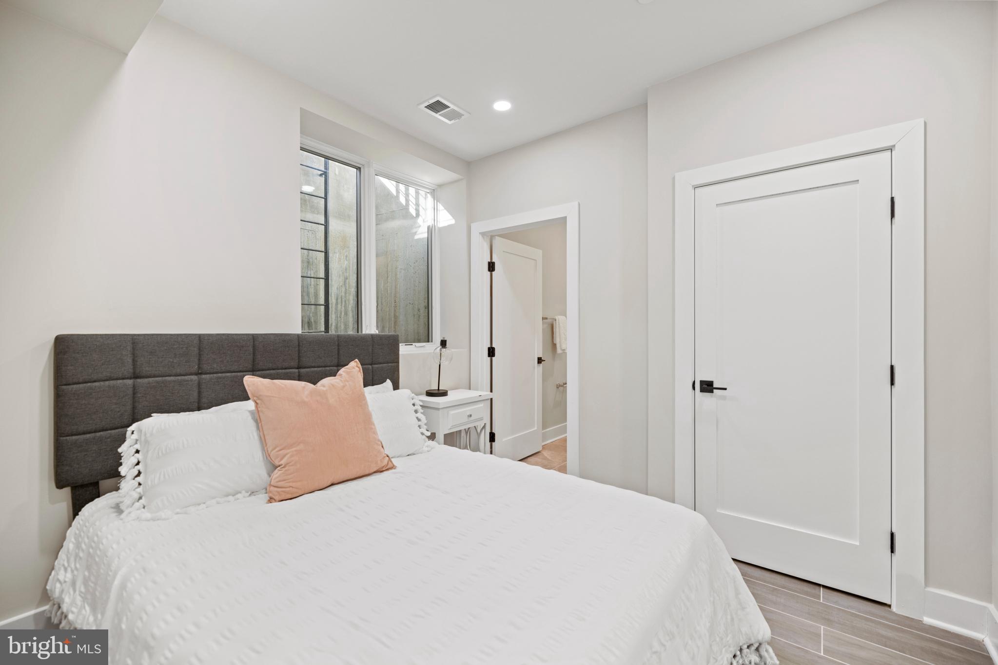 824 18th Street Northeast, Unit 3 Washington, DC 20002 - Photo 14 of 19 a bedroom with a bed and a mirror