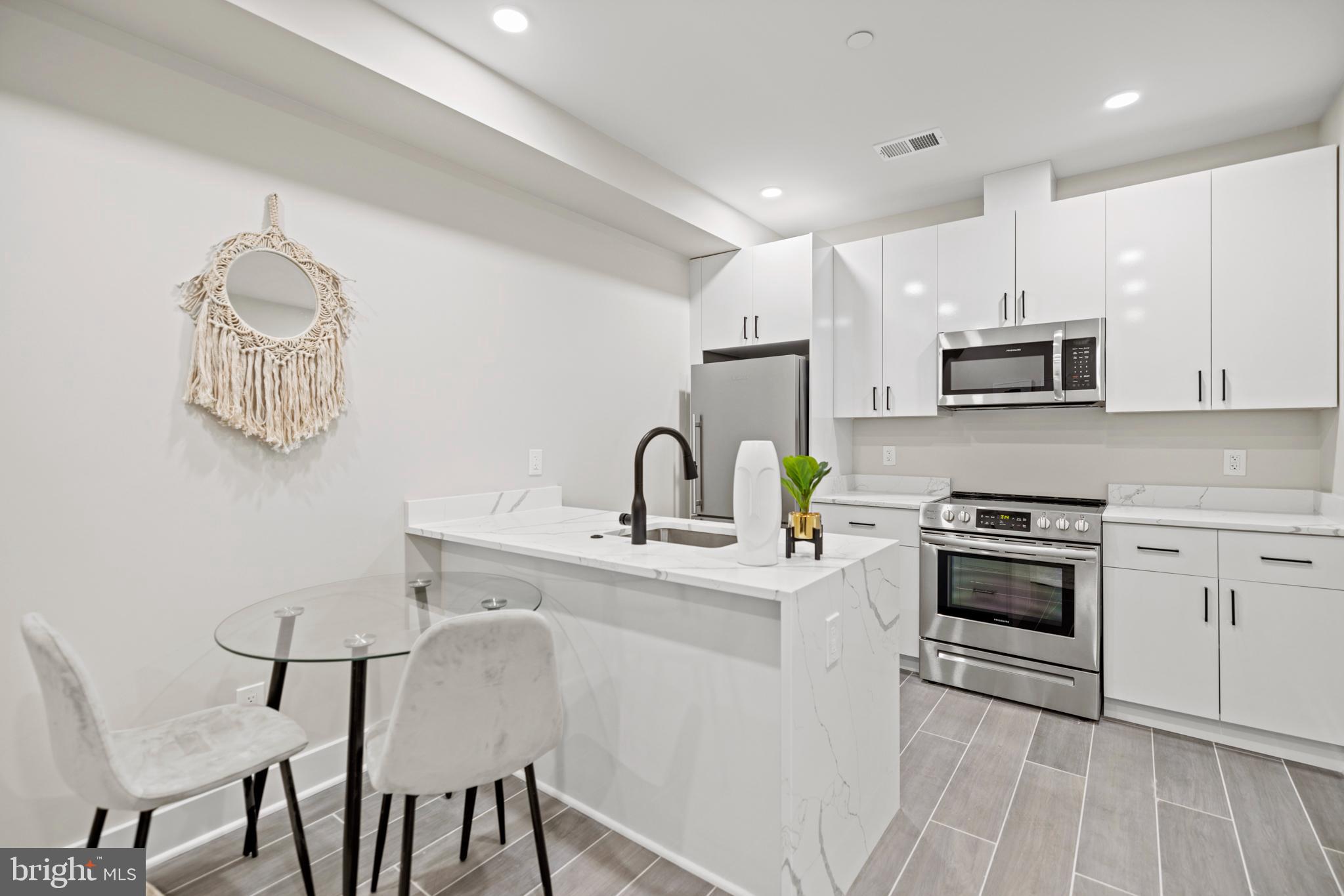 824 18th Street Northeast, Unit 3 Washington, DC 20002 - Photo 10 of 19 a kitchen with stainless steel appliances granite countertop a white stove top oven a sink and dishwasher