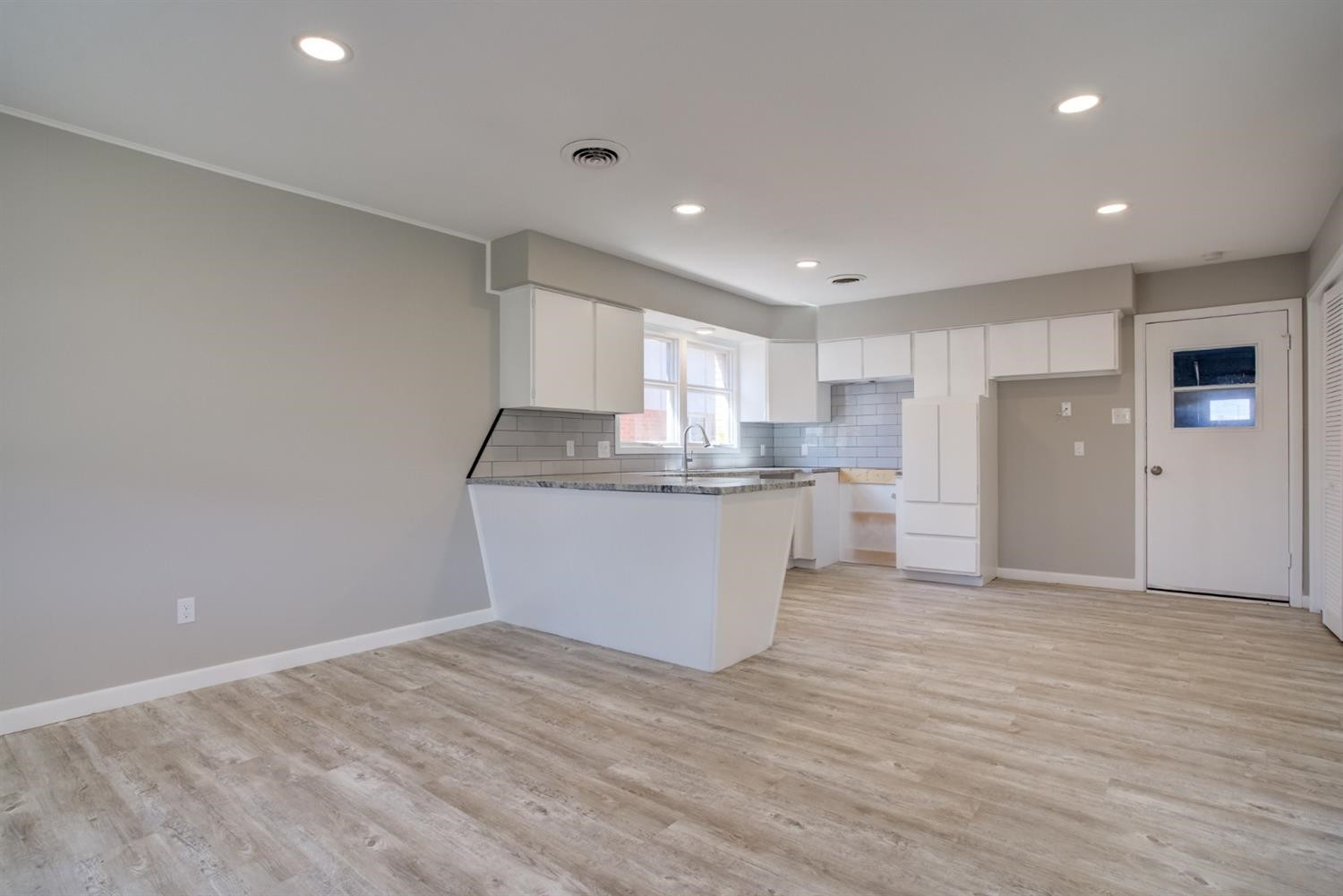 2113 66th Street Lubbock, TX 79412 - Photo 12 of 44 a view of kitchen with wooden floor and electronic appliances