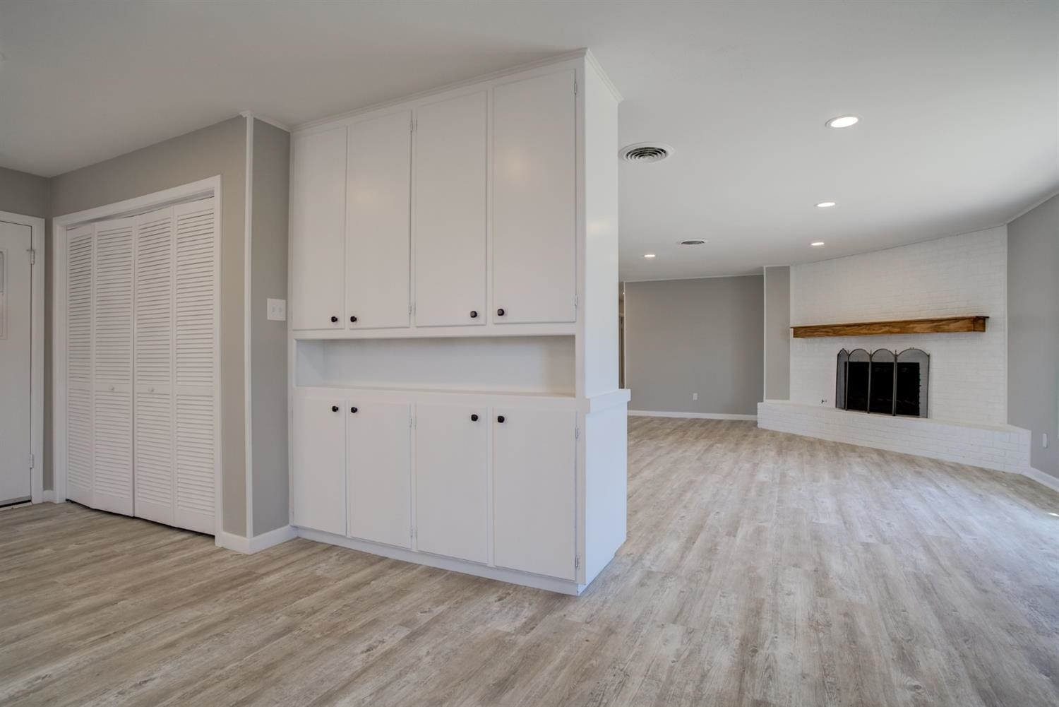 2113 66th Street Lubbock, TX 79412 - Photo 15 of 44 a view of empty room with wooden floor and fireplace